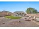 Landscaped backyard with a putting green and fire pit at 11930 W Monroe St, Avondale, AZ 85323