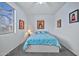 Bright bedroom with a comfortable bed and artwork at 11930 W Monroe St, Avondale, AZ 85323