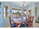 Bright dining area with wood table and chairs, offering a view of the backyard at 11930 W Monroe St, Avondale, AZ 85323