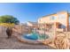 Relaxing kidney-shaped pool, partially fenced backyard with patio furniture at 12305 W Flores Dr, El Mirage, AZ 85335