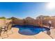 Inviting kidney shaped pool with patio furniture and a rock waterfall feature at 12305 W Flores Dr, El Mirage, AZ 85335