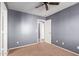 Bright bedroom featuring ceiling fan and neutral walls at 12305 W Flores Dr, El Mirage, AZ 85335