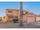 Two-story house with a large garage and desert landscaping at 12305 W Flores Dr, El Mirage, AZ 85335