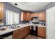 Well-equipped kitchen featuring wood cabinets and modern appliances at 12305 W Flores Dr, El Mirage, AZ 85335