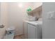 Convenient laundry room with washer, dryer, and shelving at 12305 W Flores Dr, El Mirage, AZ 85335