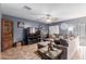 Spacious living room with L-shaped sectional sofa and large TV at 12305 W Flores Dr, El Mirage, AZ 85335