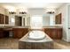 Spa-like bathroom with a large soaking tub and double vanity at 13347 W Via Caballo Blanco --, Peoria, AZ 85383