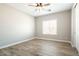 Well-lit bedroom featuring wood-look flooring and a ceiling fan at 13347 W Via Caballo Blanco --, Peoria, AZ 85383