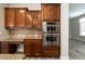 Kitchen with built-in double oven, granite countertop and wood cabinets at 13347 W Via Caballo Blanco --, Peoria, AZ 85383