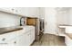 Laundry room with white cabinets, wood countertops, and a farmhouse sink at 13347 W Via Caballo Blanco --, Peoria, AZ 85383