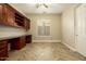 Home office with built-in wood desk and shelving, and herringbone flooring at 13347 W Via Caballo Blanco --, Peoria, AZ 85383