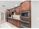 Kitchen with stainless steel appliances and wood cabinetry at 13438 W Ashwood Dr, Sun City West, AZ 85375