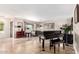 Spacious living room with a grand piano and tile floors at 13438 W Ashwood Dr, Sun City West, AZ 85375