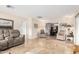 Bright living room with neutral tile floors and comfy seating at 13438 W Ashwood Dr, Sun City West, AZ 85375