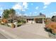 Ranch style home with a large driveway and well-manicured lawn at 1374 W 16Th St, Tempe, AZ 85281