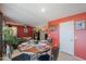 Dining area with dark wood table and red walls at 1406 S Navajo Ln, Coolidge, AZ 85128