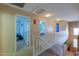 Upstairs hall with light-colored carpet and access to bedrooms at 1406 S Navajo Ln, Coolidge, AZ 85128