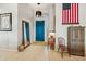 Bright entryway with teal door, full-length mirror, and wood cabinet at 14501 N Lark Ct, Fountain Hills, AZ 85268