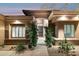 Home's entrance with lush greenery and a decorative door at 14501 N Lark Ct, Fountain Hills, AZ 85268