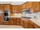 Well-equipped kitchen with wood cabinetry and stainless steel appliances at 14501 N Lark Ct, Fountain Hills, AZ 85268