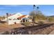 White stucco house with red tile roof, palm trees, and mountain views at 16544 E Trevino Dr, Fountain Hills, AZ 85268