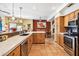 Open kitchen with wooden cabinets, granite counters, and stainless steel appliances at 17203 E Calaveras Ave, Fountain Hills, AZ 85268