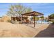 Expansive backyard with a sparkling pool and covered patio at 17203 E Calaveras Ave, Fountain Hills, AZ 85268