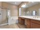 Elegant bathroom with double vanity, soaking tub, and shower at 18473 W Piedmont Rd, Goodyear, AZ 85338