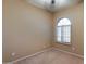 Simple bedroom with arched window and ceiling fan at 18473 W Piedmont Rd, Goodyear, AZ 85338