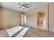 Spacious bedroom with ceiling fan and en-suite bathroom access at 18473 W Piedmont Rd, Goodyear, AZ 85338