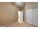 Bedroom with double door closet and access to another room at 18473 W Piedmont Rd, Goodyear, AZ 85338