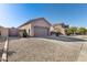 Two-car garage with gravel driveway and desert landscaping at 18473 W Piedmont Rd, Goodyear, AZ 85338