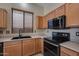 Kitchen features stainless steel appliances and wood cabinets at 18473 W Piedmont Rd, Goodyear, AZ 85338