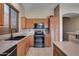 Kitchen with light wood cabinets, black appliances, and double oven at 18473 W Piedmont Rd, Goodyear, AZ 85338