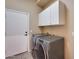 Laundry room with washer, dryer, and cabinets at 18473 W Piedmont Rd, Goodyear, AZ 85338