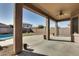 Spacious covered patio with ceiling fan, adjacent to the pool at 18473 W Piedmont Rd, Goodyear, AZ 85338