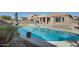 Relaxing kidney-shaped pool with patio and umbrellas at 18473 W Piedmont Rd, Goodyear, AZ 85338