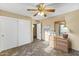 Bedroom with tiled floors, double door closet, and ceiling fan at 19806 N Stardust Blvd, Sun City West, AZ 85375