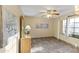 Bright bedroom with tiled floor, ceiling fan, and wood dresser at 19806 N Stardust Blvd, Sun City West, AZ 85375