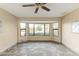 Gathering room featuring a large bay window and tile floors at 19806 N Stardust Blvd, Sun City West, AZ 85375