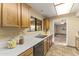 Kitchen features wood cabinets, tile flooring and stainless steel dishwasher at 19806 N Stardust Blvd, Sun City West, AZ 85375