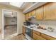 Kitchen features wood cabinets and tile flooring at 19806 N Stardust Blvd, Sun City West, AZ 85375