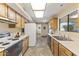 Open kitchen with wood cabinets and tile floors at 19806 N Stardust Blvd, Sun City West, AZ 85375