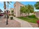 Attractive exterior of condo building with landscaping and walkway at 205 N 74Th St # 159, Mesa, AZ 85207