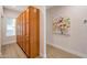 Hallway with wooden cabinets and artwork at 205 N 74Th St # 159, Mesa, AZ 85207