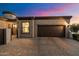 Home exterior at dusk with dark brown garage door at 2129 N Atwood --, Mesa, AZ 85207