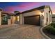 Home exterior at dusk with a brick driveway at 2129 N Atwood --, Mesa, AZ 85207