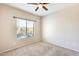 Bedroom with window and ceiling fan at 21655 N 36Th Ave # 106, Glendale, AZ 85308