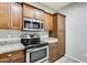 Modern kitchen with stainless steel appliances and wood cabinets at 21655 N 36Th Ave # 106, Glendale, AZ 85308