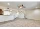 Spacious living room featuring a ceiling fan and wood-look tile floors at 21655 N 36Th Ave # 106, Glendale, AZ 85308